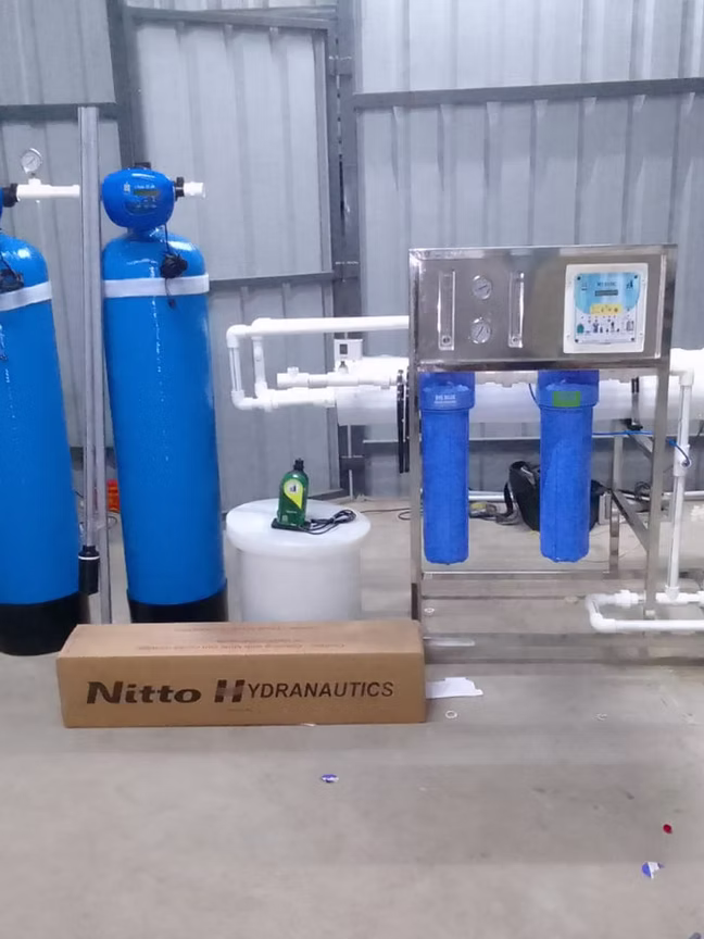 Twin-tank water treatment system installed in a commercial shed