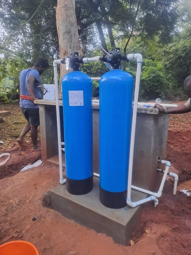 Twin-tank system installed outdoors near landscaping