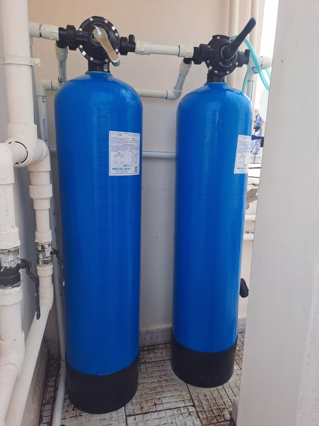 Wall-mounted water treatment system with valve assembly